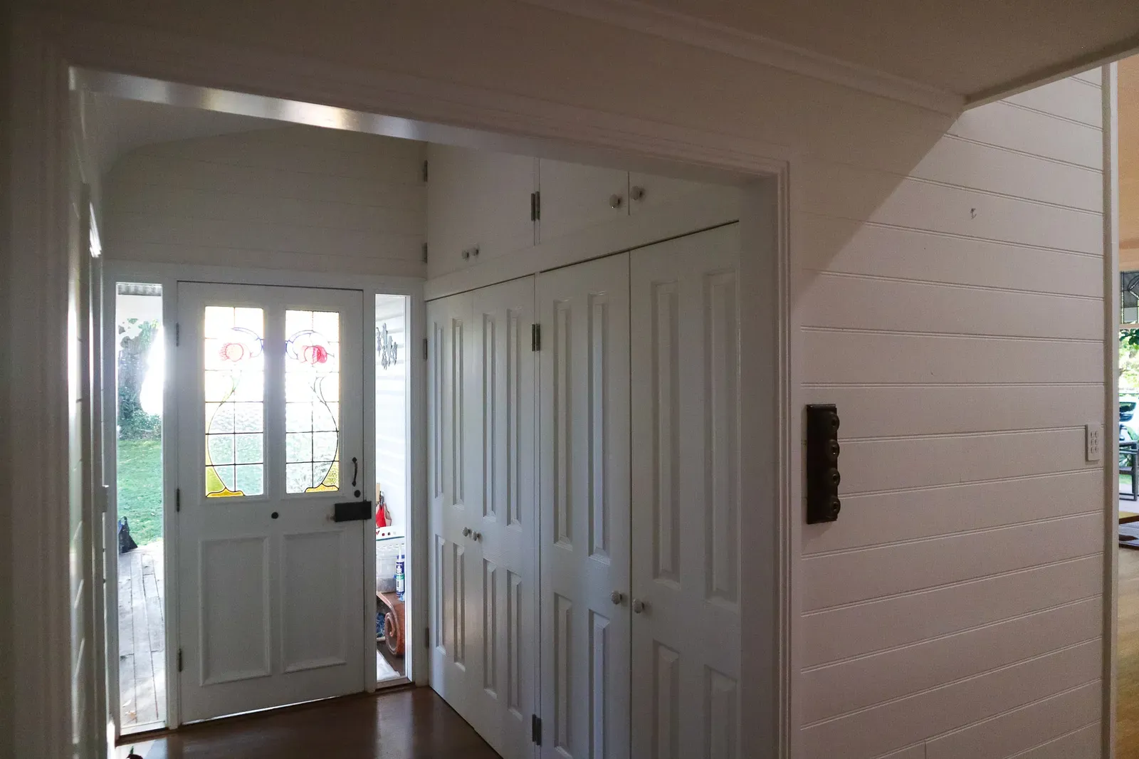The entry hall with its leadlight front door and built-in cabinetry